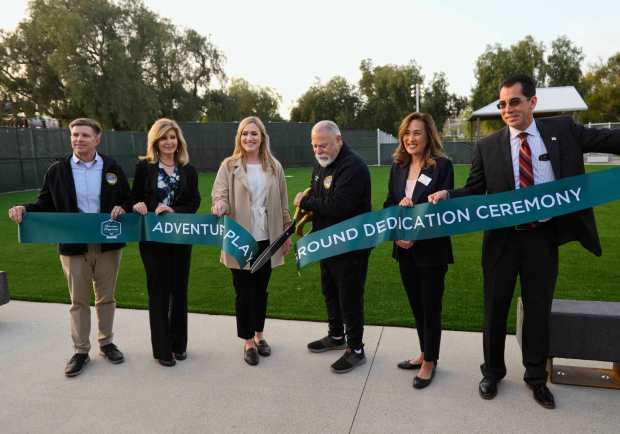 Yorba Linda city manager Mark Pulone, councilperson Beth Haney, Mayor Pro Tem Tara Campbell, Mayor Gene Hernandez, councilperson Janice Lim and councilman Carlos Rodriguez, from left, join in cutting the ribbon for the newly renovated Adventure Playground in Yorba Linda on Friday, April 14, 2023. (Photo by Paul Rodriguez, Contributing Photographer)