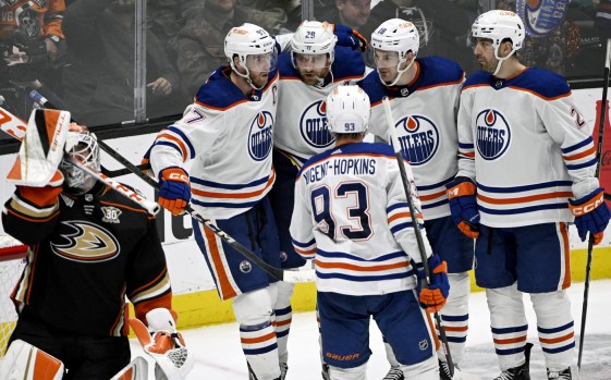 Ducks goaltender Lukas Dostal, left, shows his frustration as Edmonton Oilers players celebrate a go-ahead goal by Leon Draisaitl (29) during the third period on Friday night at the Honda Center. (AP Photo/Alex Gallardo)
