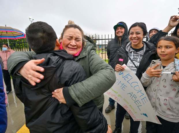 Sandra Rivera greets her son, Juan Rivera, as he arrives from outdoor science camp at George B. Miller Elementary School in La Palma, CA, on Monday, February 27, 2023. A truck accident and the recent blizzard delayed the return of 72 sixth graders from the San Bernardino Mountains by four days. (Photo by Jeff Gritchen, Orange County Register/SCNG)