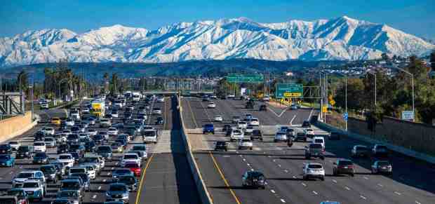 The view looking north at the snow-covered San Gabriel Mountains from the E. La Veta Avenue overpass of the 55 freeway in Orange on Thursday morning, March 2, 2023. After days of rain, wind, and snow, the clouds cleared away, leaving snow-covered mountains for motorists and those getting outside to view from all over Southern California. (Photo by Mark Rightmire, Orange County Register/SCNG)