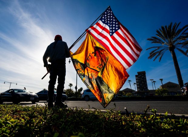A man stands at the curb at a rally for Donald Trump at the intersection of El Toro Road and Avenida de Carlota in Laguna Hills on Tuesday, April 4, 2023 in reaction to 34 felony criminal charges against the former president. (Photo by Leonard Ortiz, Orange County Register/SCNG)