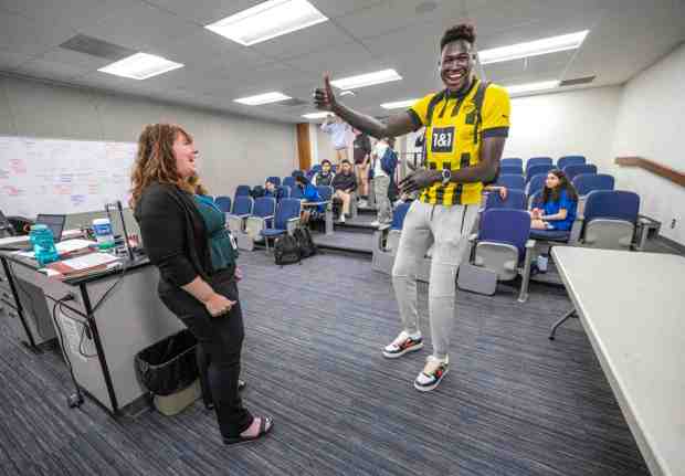 Dut Lual, right, an 18-year-old native of war-torn Sudan, gives the thumbs-up to his IB chemistry teacher Carly Gordon, left, after they finished their secret handshake before class at Santa Margarita Catholic High School in Rancho Santa Margarita on Wednesday, May 17, 2023. The 7-foot Lual will study science and math and play basketball at Oberlin College in Ohio in the fall. (Photo by Mark Rightmire, Orange County Register/SCNG)