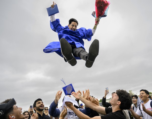 Western High School graduate Anas Mohamed gets tossed in the air as he celebrates graduation with his family and friends in Anaheim on Wednesday, May 24, 2023. (Photo by Mindy Schauer, Orange County Register/SCNG)