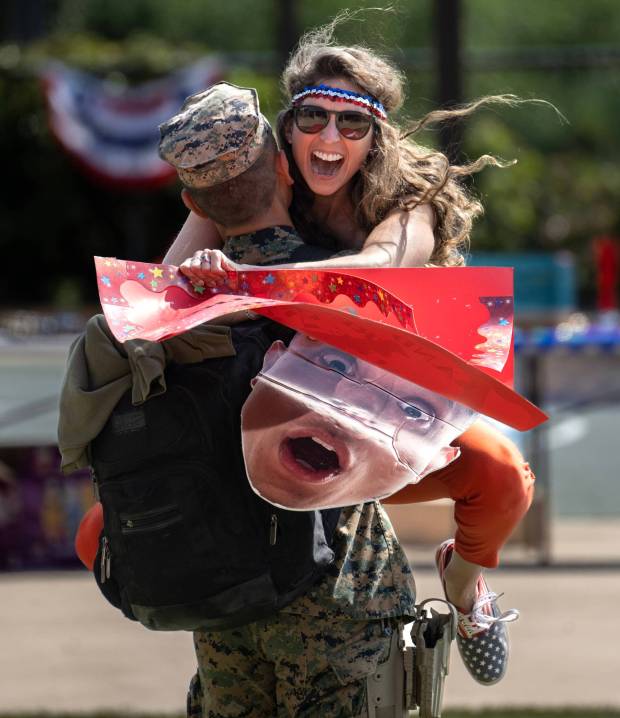 Kathryn Zahm jumps into the arms of her husband, Maj. Andrew Do, after he returns to Camp Pendleton on Tuesday, June 6, 2023 after a seven-month deployment. (Photo by Mindy Schauer, Orange County Register/SCNG)