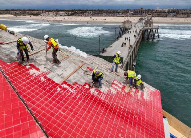 Workers replace the iconic red roof at the end of the pier in Huntington Beach, CA, on Monday, June 12, 2023. (Photo by Jeff Gritchen, Orange County Register/SCNG)