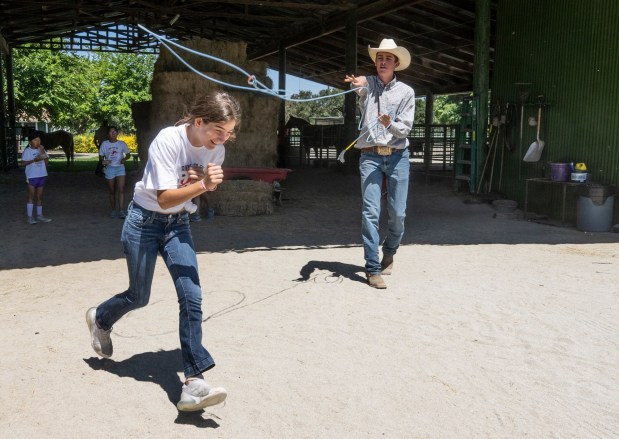 A camper tries to avoid getting roped by cowboy Deedge Laster at Cow Camp at Rancho Mission Viejo in south Orange County, CA on Tuesday, June 20, 2023. The visit to Cow Camp was part of Ranch Camp through the YMCA of Orange County. (Photo by Paul Bersebach, Orange County Register/SCNG)