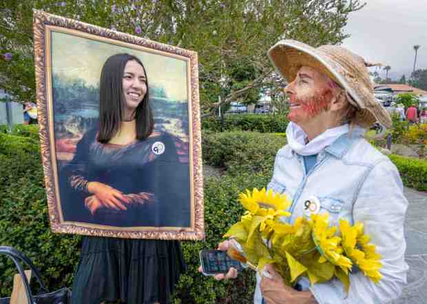 Parade participants Sophie Higuchi, left, dressed as Mona Lisa and Sue Ziehmer, right, dressed as Vincent van Gogh, chat in Heisler Park in Laguna Beach before the start of the parade as the Pageant of the Masters celebrated the 90 years of Living Pictures with a sidewalk parade of costumes on Saturday, July 22, 2023. The event made its way to Main Beach, through downtown, and ended at the Pageant of the Masters at the Festival of Arts grounds on Laguna Canyon Road. (Photo by Mark Rightmire, Orange County Register/SCNG)