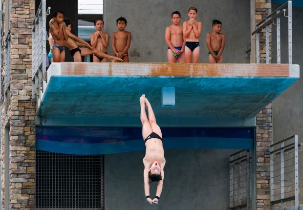 A diver executes a dive off the platform as other divers watch and wait their turn to dive during the USA Diving Junior National Championships at the Marguerite Aquatic Complex in Mission Viejo on Sunday, July 23, 2023. Over 600 of the top junior divers from across the country will be competing in in four events and three age groups July 23-August 1. (Photo by Leonard Ortiz, Orange County Register/SCNG)