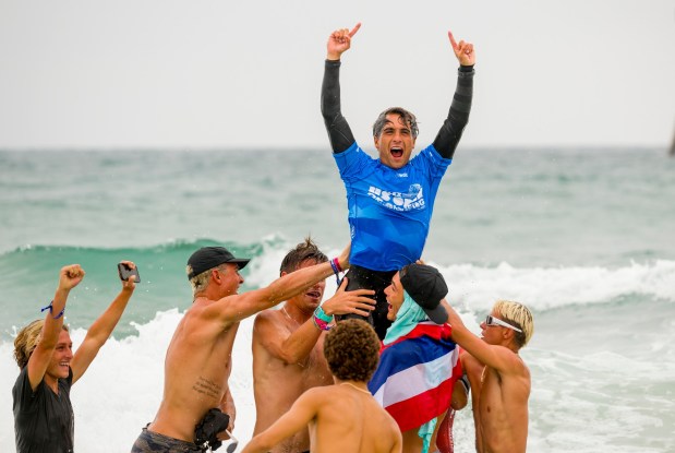Supporters raise up an exuberant Eli Hanneman after he won the Men's US Open of Surfing in Huntington Beach on Sunday, August 6, 2023. (Photo by Leonard Ortiz, Orange County Register/SCNG)