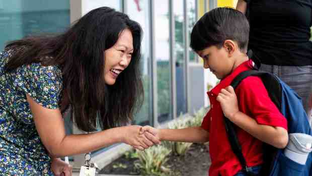 Student Aryana Nathan greets her first grade teacher Julie Smith on the first day of class at Roosevelt Elementary School in Anaheim, CA on Thursday, August 10, 2023. (Photo by Paul Bersebach, Orange County Register/SCNG)
