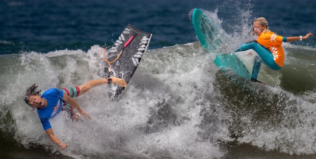 Kalani Robb, left, and Harvey Nelson cross paths and collide during the Red Bull Foam Wreckers light-hearted surfing competition in San Clemente on Saturday, August 12, 2023. (Photo by Mindy Schauer, Orange County Register/SCNG)