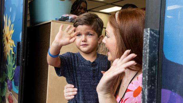 Baron Myers waves good-bye to his mom with the help of his transitional kindergarten teacher Kristyn Day on the first day of class at Andersen Elementary School in Newport Beach, CA on Monday, August 21, 2023. (Photo by Paul Bersebach, Orange County Register/SCNG)