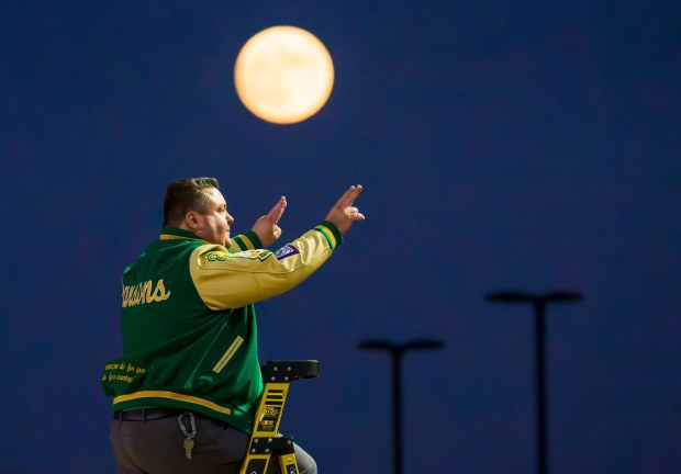 John F. Kennedy High School band director Joshua Parsons, leads the band standing on a ladder as the moon rises above the field before an Empire League football game between Kennedy and Tustin at Western High School in Anaheim on Thursday, September 28, 2023. (Photo by Leonard Ortiz, Orange County Register/SCNG)