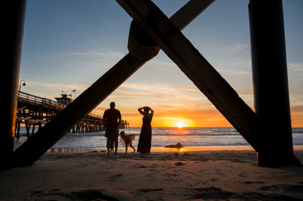 A family watches the sunset at the San Clemente Pier in San Clemente on Thursday, November 9, 2023 (Photo by Leonard Ortiz, Orange County Register/SCNG)