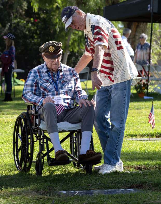 Decorated WWII Army pilot, Capt. Leland Spencer, 101, with his son Bruce Spencer, looks at the spot he will be buried with his wife who died in 2021. They were at the El Toro Memorial Park Veterans Day event in Lake Forest on Saturday, November 11, 2023. (Photo by Mindy Schauer, Orange County Register/SCNG)