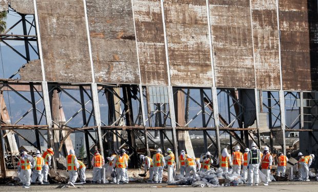 Workers in protective gear take part in hazardous waste clean up on Sunday, December 3, 2023 at the historic Marine Corps Air Station in Tustin. The hangar was destroyed in a fire last month. (Photo by Mindy Schauer, Orange County Register/SCNG)