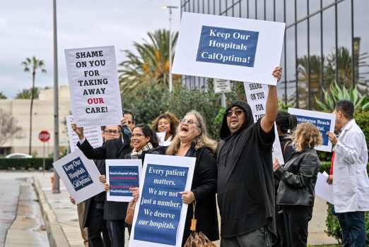 Robin Wilson, a patient, and Billy San Juan, a patient advocate, join others they protest CalOptimaxe2x80x99s decision to cancel a contract with four Orange County hospitals in Orange, on Thursday, Feb. 1, 2024. (Photo by Jeff Gritchen, Orange County Register/SCNG)
