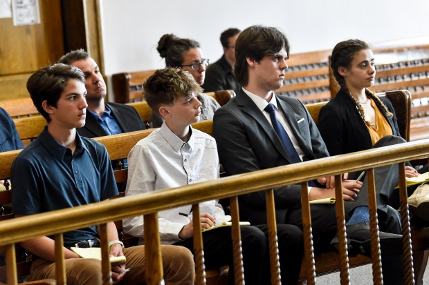 Plaintiffs listen to arguments during a status hearing on May 12, 2023, in Helena, Mont., for a case that they and other Montana youth filed against the state arguing Montana officials are not meeting their constitutional obligations to protect residents from climate change. (Thom Bridge/Independent Record via AP)