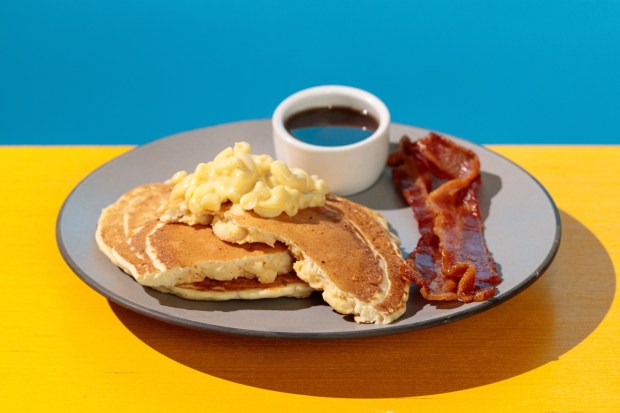 Schroeder's Fluffy Breakfast Mac and Cheese Pancake served with a side of Bacon and Maple Syrup served during the Peanuts Celebration at Knott's Berry Farm. (Photo courtesy of Knott's)