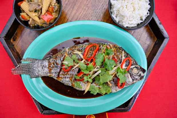 Whole fish with steamed rice and stir-fried vegetables, served family-style for two available at Paradise Garden Grill during Lunar New Year at Disney California Adventure on Tuesday, Jan. 23, 2024, in Anaheim, CA. ..(Photo by Jeff Gritchen, Orange County Register/SCNG)
