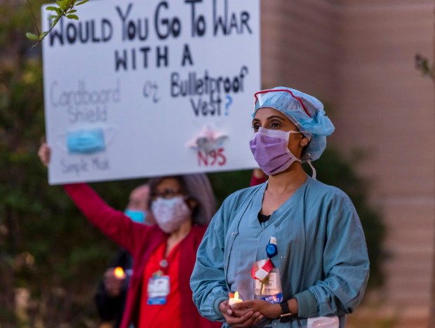 UCI nurses hold a candlelight vigil during the shift-change outside UCI Medical Center in Orange on Monday, April 20, 2020 to protest over concerns about having enough personal protective equipment for health care workers treating COVID-19 patients. The vigil also to honored health care workers who have contracted COVID-19. (Photo by Leonard Ortiz, Orange County Register/SCNG)