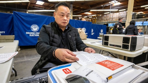 Huy Nguyen, an Orange County Registrar of Voters staff member, scans test ballots into a Verity Scan device on Friday, February 9, 2024, in Santa Ana. The marked test ballots and scanning are part of a state-mandated logic and accuracy testing of the machines and processes of the OC Registrar of Voters, which is done for California’s upcoming March 5th primary. (Photo by Mark Rightmire, Orange County Register/SCNG)
