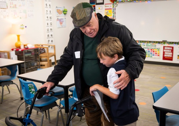 Easton Dennis gets a hug from his grandpa Roger Dennis during Grandparents and Special Friendxe2x80x99s Day at St. Maryxe2x80x99s School in Aliso Viejo, CA on Friday, Nov. 17, 2023. Grandparents were shown around the school and the studentsxe2x80x99 latest work. (Photo by Paul Bersebach, Orange County Register/SCNG)