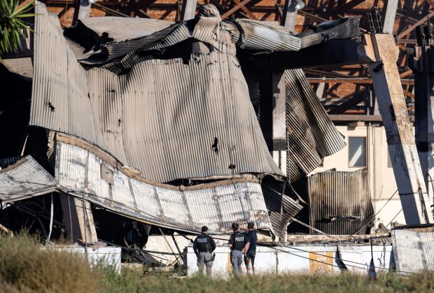 Officials investigate the rubble of the historic Tustin Marine Corps Air Station blimp hangar on Wednesday, Nov. 8, 2023 after a fire destroyed the WWII-era structure. (Photo by Mindy Schauer, Orange County Register/SCNG)