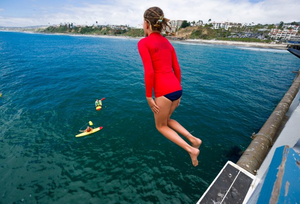 San Clemente Junior Lifeguard Rooney Beatty, 11, jumps off the San Clemente Pier in San Clemente on Monday, June 19, 2023. (Photo by Leonard Ortiz, Orange County Register/SCNG)
