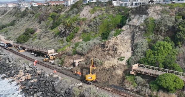 Workers inspect a landslide site in San Clemente on Friday, Jan. 26 2024, where a popular pedestrian bridge was closed and a landslide sent debris onto the rail line. (Photo courtesy of the city of San Clemente)