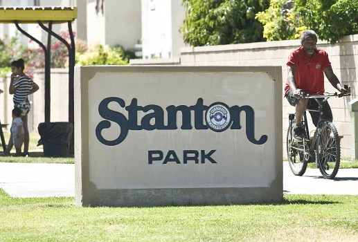 A bike rider crosses through Stanton Park. NICK AGRO, ORANGE COUNTY REGISTER
