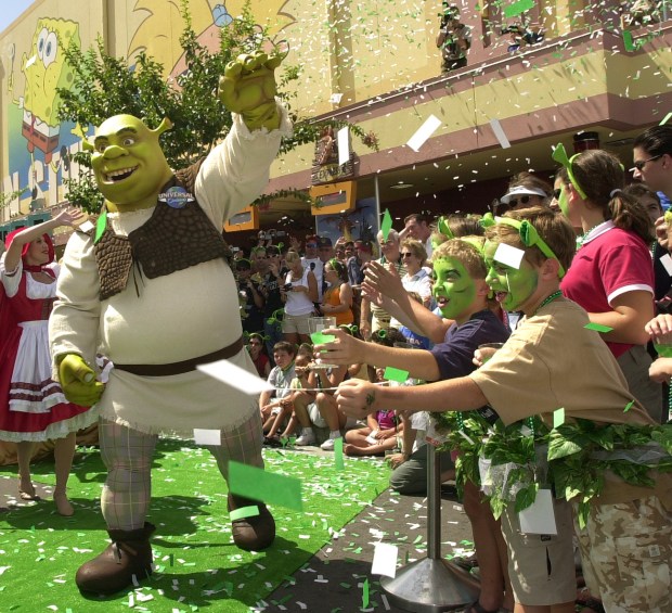 Children cheer as famed ogre Shrek arrives at the grand opening ceremony of the Shrek 4-D attraction at Universal Studios Florida in Orlando in 2003. (Joe Burbank/Orlando Sentinel)
