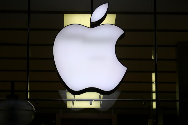 FILE - The Apple logo is illuminated at a store in the city center of Munich, Germany, Dec. 16, 2020. Apple plans to suspend sales of the Series 9 and Ultra 2 versions of its popular Apple Watch for online U.S. customers beginning Thursday afternoon, Dec. 21, 2023, and in its stores on Sunday, Dec. 24. The move stems from an Oct. decision from the International Trade Commission restricting Apple's watches with a Blood Oxygen feature as part of an intellectual property dispute with medical technology company Masimo. (AP Photo/Matthias Schrader, File)